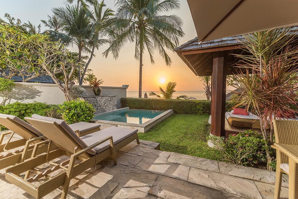 Sunset over the private pool villas at The Sunset Beach Resort & Spa
